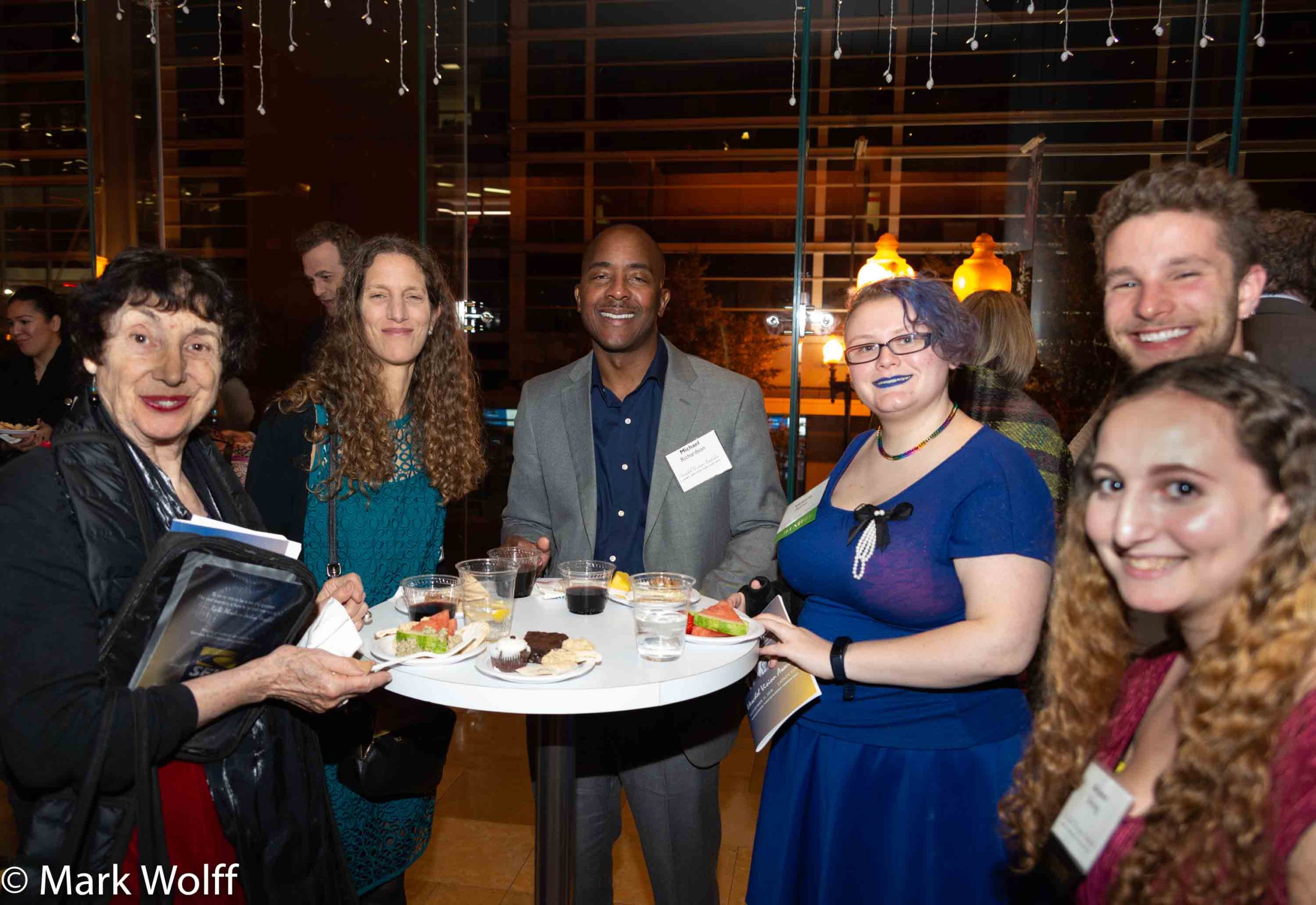 people smile around a table at a reception
