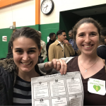 smiling young women hold a FY20 budget plan