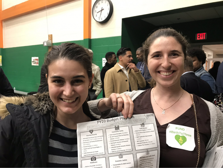 anniebudgetforum smiling young women hold a FY20 budget plan