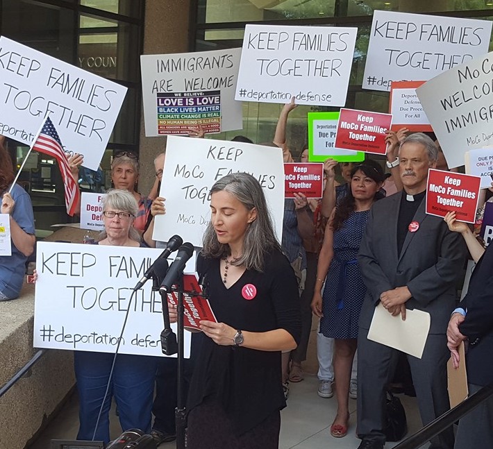 protest-photo-cropped protesters holding signs supporting immigration justice